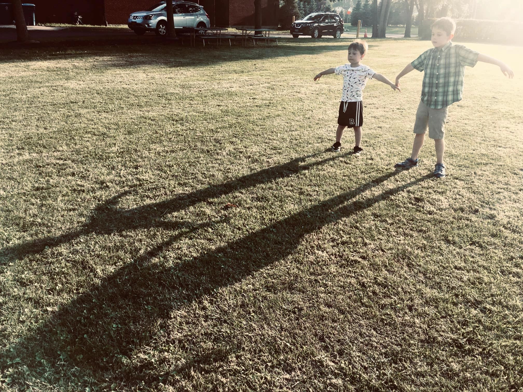 Children together on the church lawn at golden hour