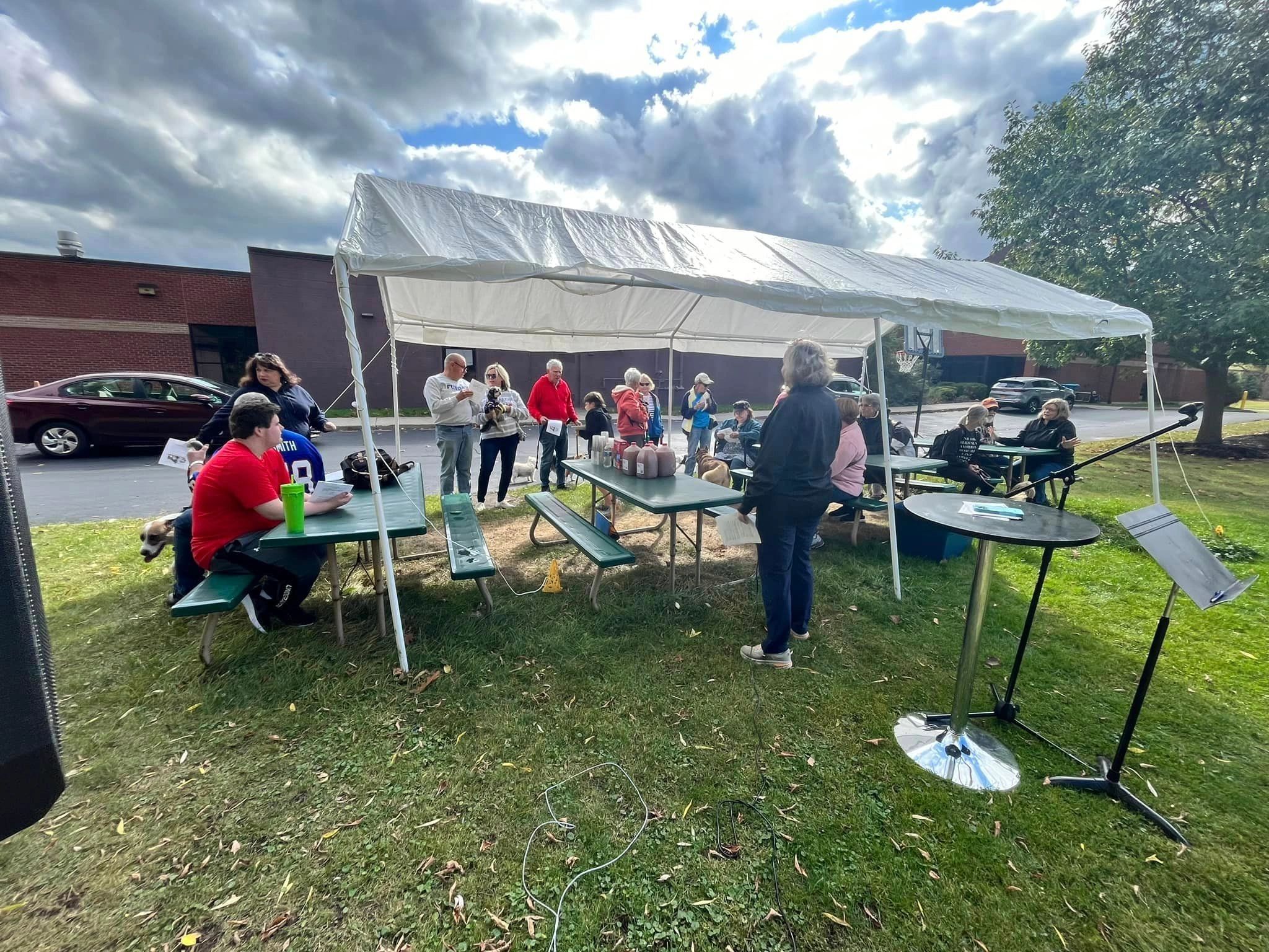 Community gathered under a tent for the annual pet blessing