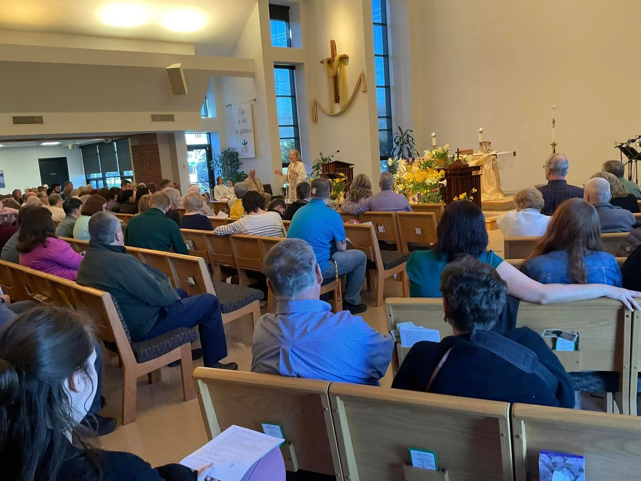 Easter Sunday worship at Lord of Life, sanctuary with daffodils and the cross